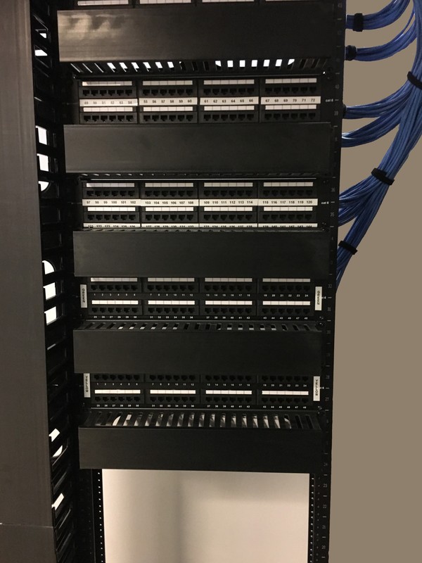 Professional cable installers performing network and Wi-Fi installation at office relocation site